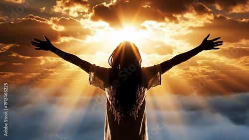 Person silhouette with arms raised reaching sky above golden clouds