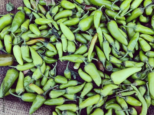 fresh green chillies on a vegetable shop
