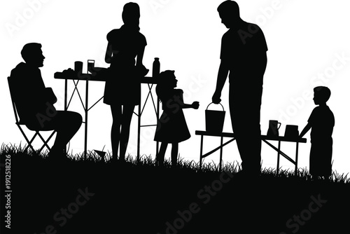 Silhouette of happy family with children having outdoor summer picnic on grass with tables and food for healthy lifestyle concept