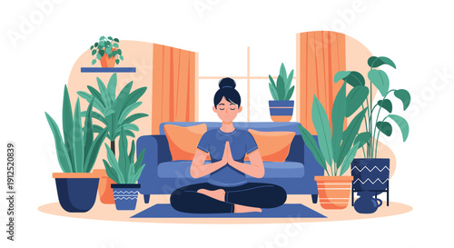 Young woman practicing mindfulness meditation while sitting in a lotus pose on a yoga mat in her bright living room surrounded by plants.