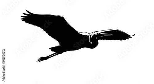 Silhouette of a flying heron, a majestic bird soaring through the sky with outstretched wings.