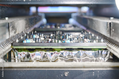 Quadro em tela Wave soldering process for PCB tinning in molten solder bath in an electronics m
