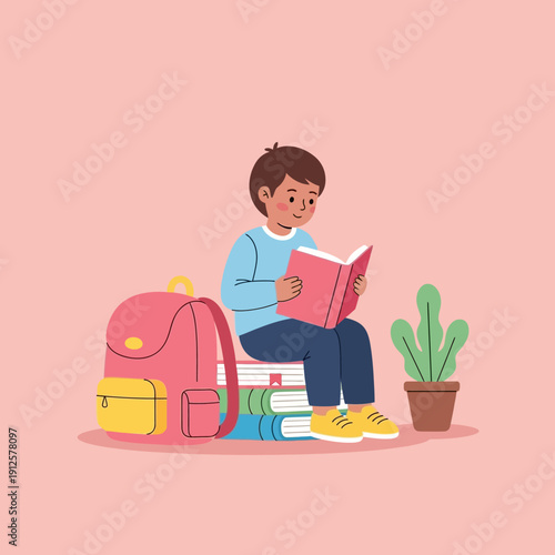 Young boy reading a book while sitting on a stack of books, backpack and plant nearby