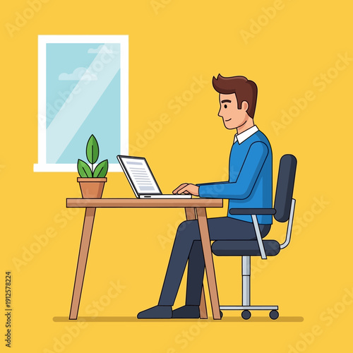 Man working on a laptop at a desk in a bright room with a window and a plant.