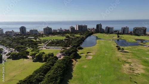 Drone orbits left around southern side of Green Point Park on a sunny day in Cape Town, South Africa