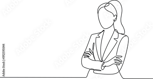 Woman in a Blazer with Arms Crossed Standing at a Table