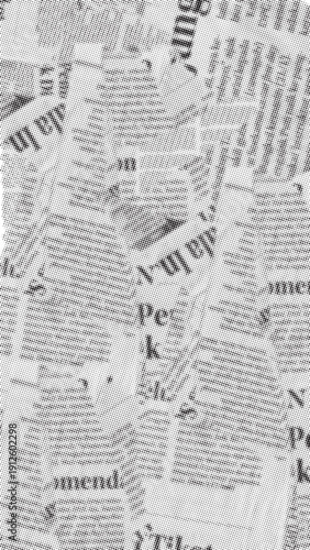 Overlapping torn pieces of black and white newspaper create abstract background texture