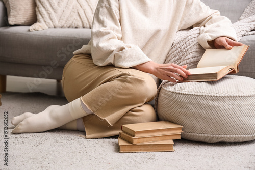 Young woman reading book on...
