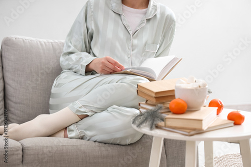 Young woman reading book on...