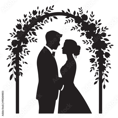 Bride and groom silhouette standing under floral wedding arch