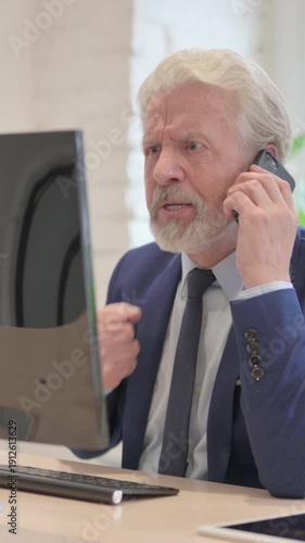 Angry Senior Old Businessman Talking on Phone at Work, vertical video
