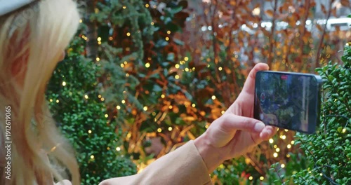 Woman Taking Holiday Photos in Festive Garden