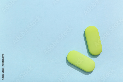 Green rubber erasers on blu...
