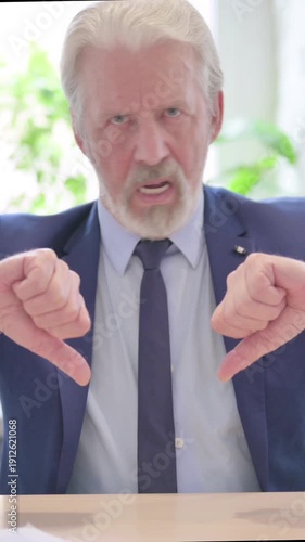Upset Senior Old Businessman showing Thumbs Down, vertical video
