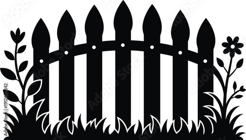 Black picket fence with flowers and grass garden