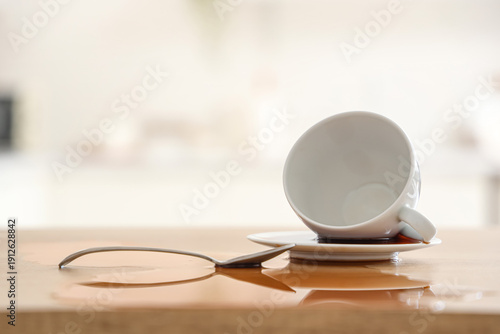 Overturned cup with spoon a...