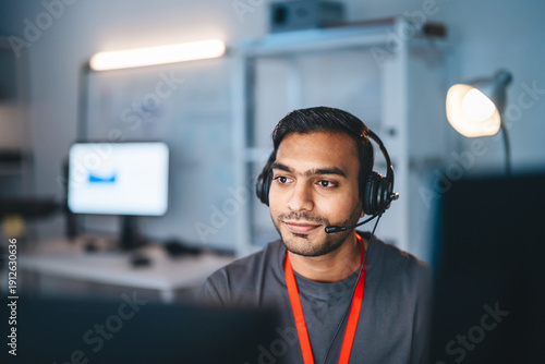Portrait young adult indian man wearing headset remote work online technical support business customer service at home