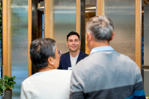 A couple senior traveler checking in for the hotel reservation area to relax for travel in the city , Co-working space area.