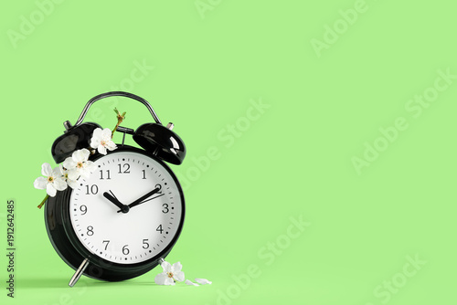 Alarm clock and flowers on ...