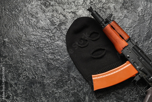 Balaclava with rifle on bla...