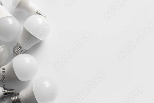 Many light bulbs on grey ba...
