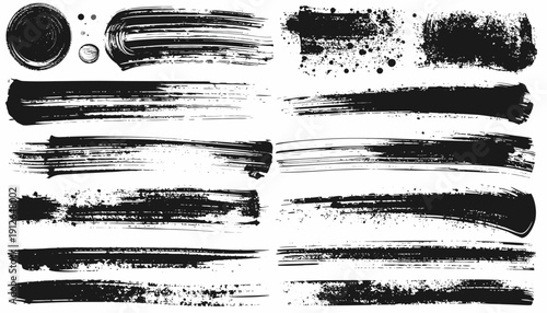 Collection of various black brush strokes and ink splatters on a textured surface viewed from directly above