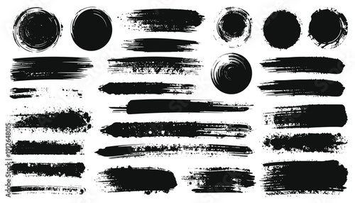 Collection of various black brush strokes and circular shapes on a clean background viewed from a straightforward perspective.