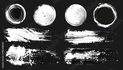 Collection of white brush strokes and circular smudges on a black background displayed prominently