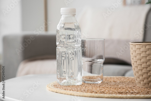 Bottle of water and glass o...