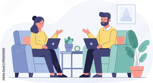 Two people sitting in comfortable chairs, laptops open, engaging in conversation