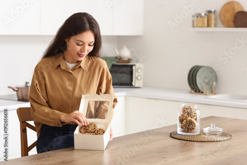 Young Asian woman with box ...