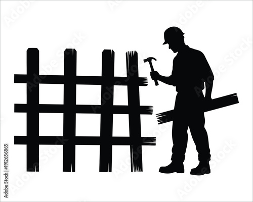Silhouette of a man building or repairing a wooden fence