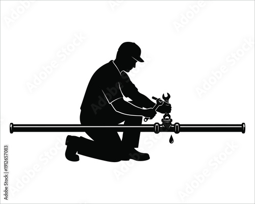 Silhouette of a man working on a long pipe with a valve