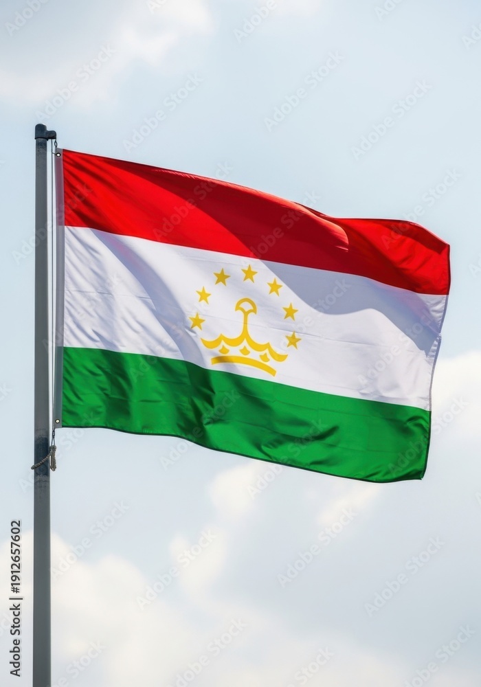 Fototapeta premium Tajikistan Flag Waving Under Clear Sky