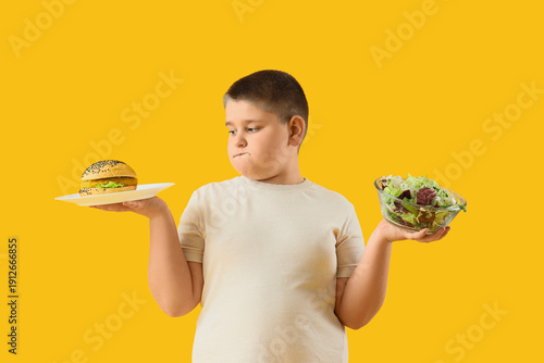 Thoughtful overweight boy w...