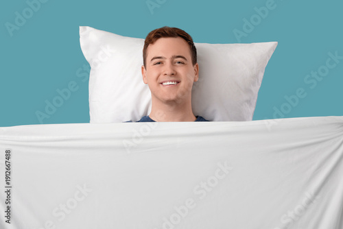 Young man with pillow and b...