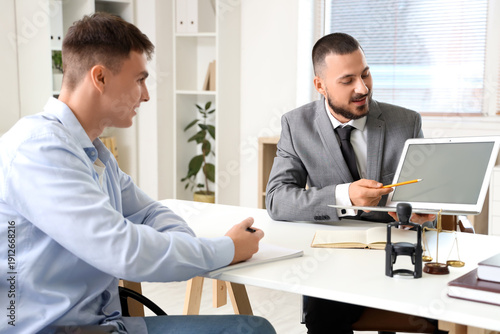 Male lawyer showing laptop ...