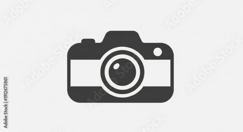Dark gray camera icon with white accents on light background symbolizing photography and creativity tools