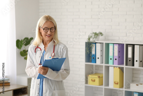 Female doctor writing in clipboard at hospital