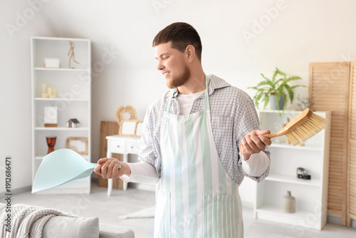 Young man in apron holding ...