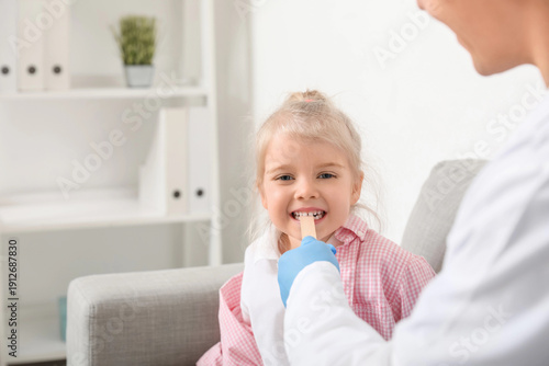 Pediatrician examining litt...