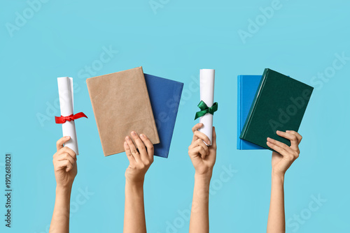 Female hands with diplomas ...