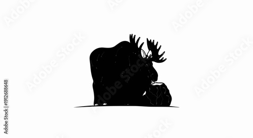 A black silhouette of a moose with large antlers stands near a rock