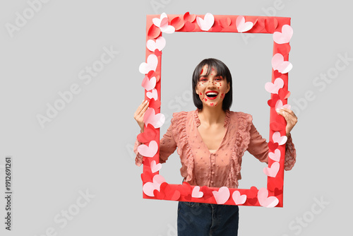 Cheerful young woman holdin...