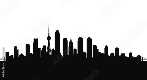 Cityscape silhouette with prominent skyscrapers and iconic tower viewed from a distance at dusk