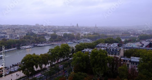 High-angle view of the Seine River and Paris cityscape under rainy overcast sky