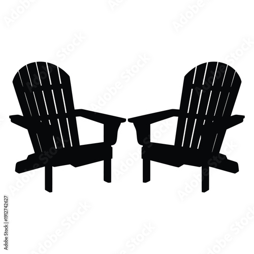 Two black adirondack chairs facing each other in a simple design
