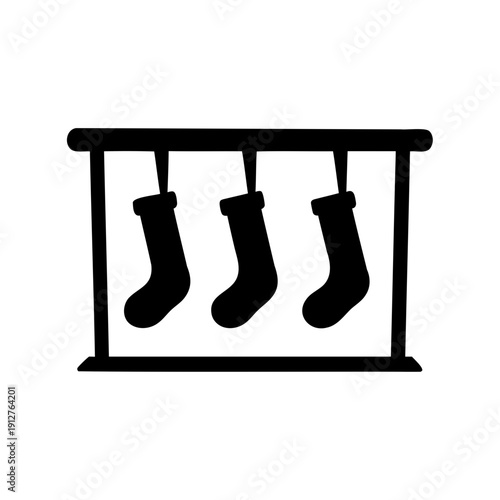 Three simple silhouette Christmas stockings hanging by a fireplace mantelpiece