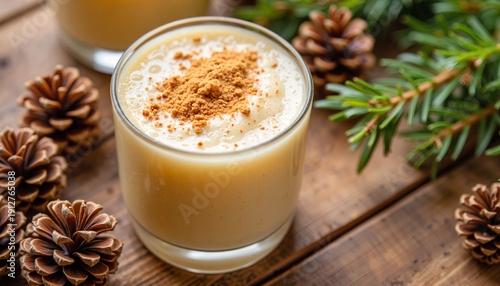 Classic eggnog cocktail with nutmeg on wooden surface, holiday vibes