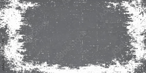 An abstract black grunge background with a vintage painted texture features a dirty rough wall pattern and grey liquid splash design on a cold weathered surface